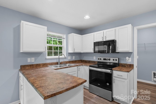 120 Alpine Ridge Dr, Asheville, NC 28803 - kitchen with electric stove, black microwave, dark countertops, white cabinets, and recessed lighting