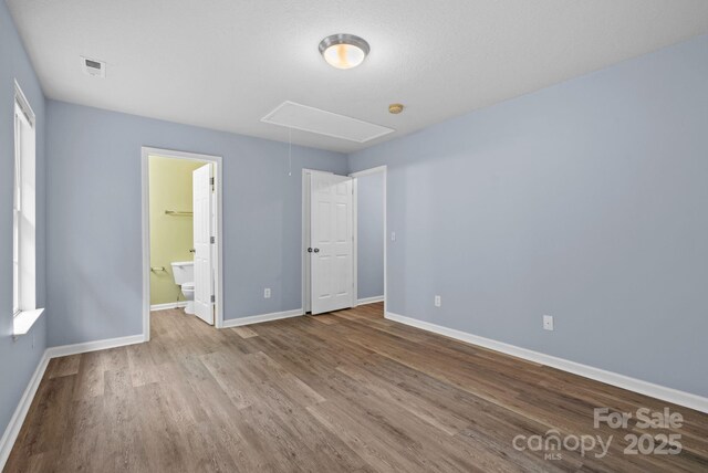 120 Alpine Ridge Dr, Asheville, NC 28803 - unfurnished bedroom featuring attic access, wood finished floors, and ensuite bathroom