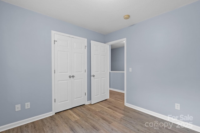 120 Alpine Ridge Dr, Asheville, NC 28803 - unfurnished bedroom with wood finished floors and a closet