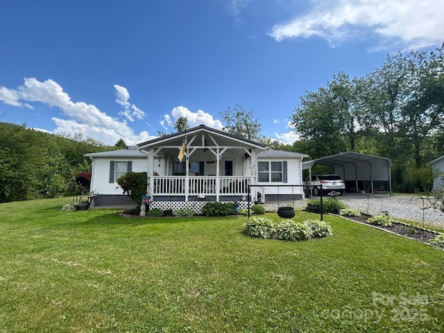 121 J F Morris Dr, Waynesville, NC 28786 - view of front of home with covered porch, driveway, a front yard, and a detached carport