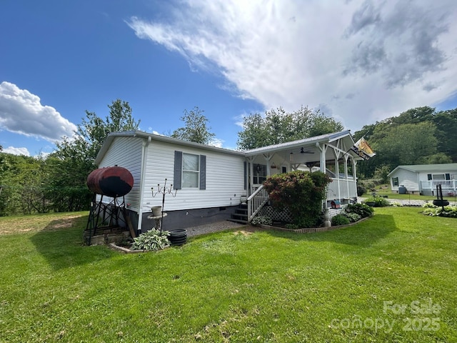 121 J F Morris Dr, Waynesville, NC 28786 - back of house featuring a yard, crawl space, and covered porch