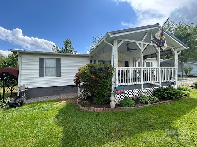 121 J F Morris Dr, Waynesville, NC 28786 - view of front of property with a ceiling fan, a front lawn, a porch, and a carport