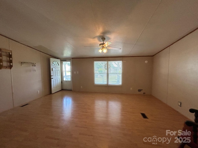 121 J F Morris Dr, Waynesville, NC 28786 - unfurnished room with wood finished floors, ceiling fan, and vaulted ceiling