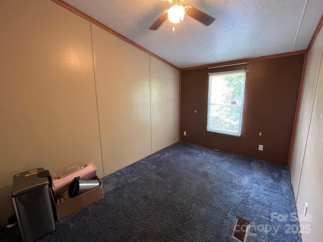 121 J F Morris Dr, Waynesville, NC 28786 - empty room featuring a textured ceiling, ceiling fan, ornamental molding, carpet floors, and lofted ceiling