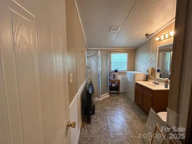 121 J F Morris Dr, Waynesville, NC 28786 - bathroom with vanity, a stall shower, crown molding, a decorative wall, and a textured ceiling