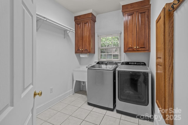 654 9th St N, Albemarle, NC 28001 - laundry room with separate washer and dryer, cabinet space, light tile patterned flooring, and baseboards