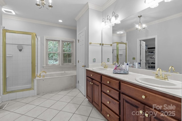 654 9th St N, Albemarle, NC 28001 - full bath featuring a stall shower, a chandelier, a bath, double vanity, and crown molding