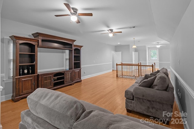 654 9th St N, Albemarle, NC 28001 - living room with a ceiling fan, light wood-style flooring, and baseboards