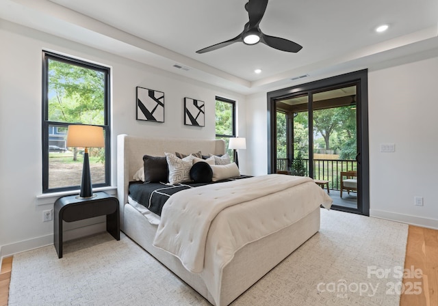 4117 Sarah Dr, Charlotte, NC 28217 - bedroom with access to exterior, light wood-style floors, a tray ceiling, recessed lighting, and ceiling fan
