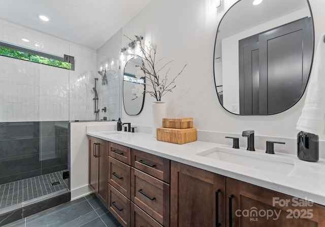 4117 Sarah Dr, Charlotte, NC 28217 - full bath with double vanity, tiled shower, tile patterned floors, and recessed lighting