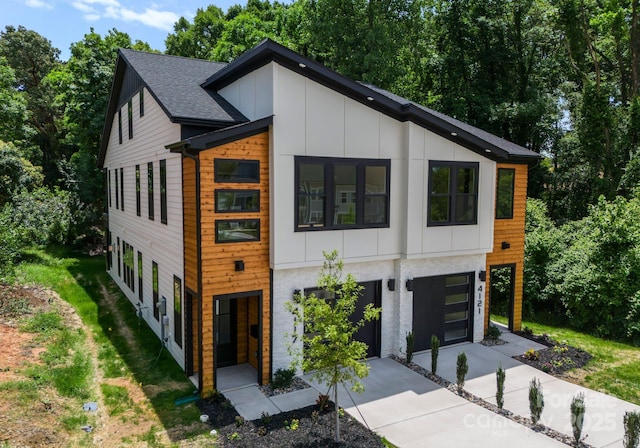 4117 Sarah Dr, Charlotte, NC 28217 - contemporary house featuring board and batten siding, driveway, and an attached garage