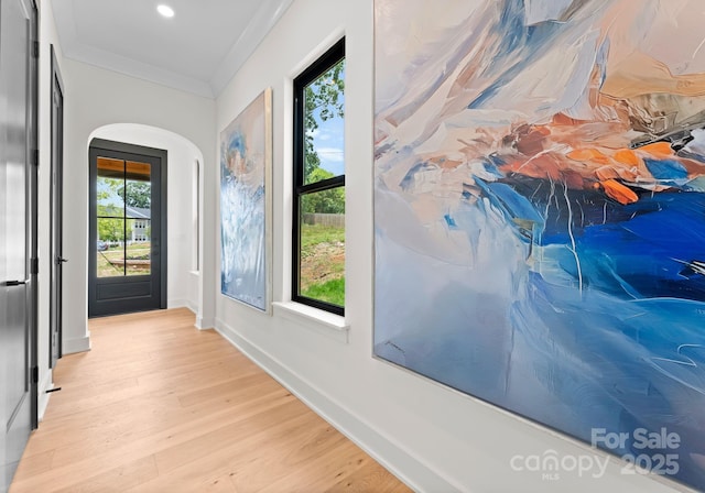 4117 Sarah Dr, Charlotte, NC 28217 - doorway to outside featuring arched walkways, light wood-type flooring, recessed lighting, and crown molding