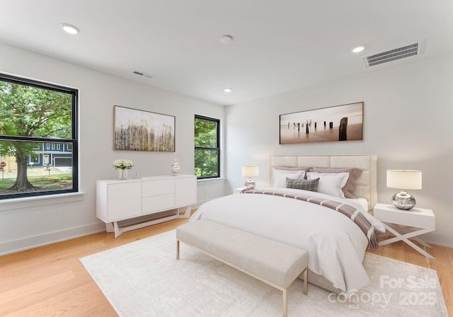 4117 Sarah Dr, Charlotte, NC 28217 - bedroom featuring multiple windows, light wood-style floors, and recessed lighting