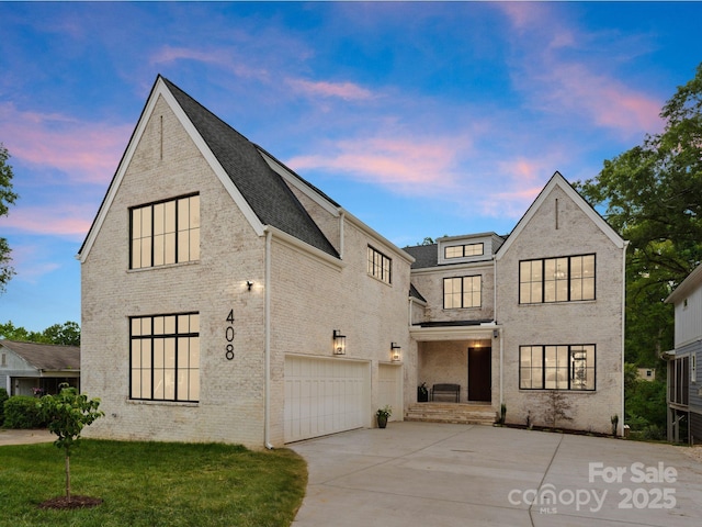408 Ideal Way, Charlotte, NC 28203 - view of front of home with an attached garage, driveway, brick siding, and a front yard