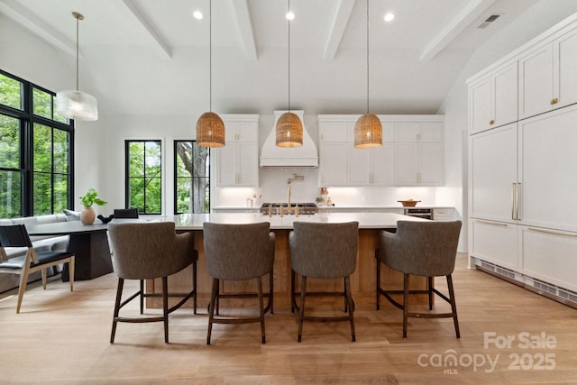 408 Ideal Way, Charlotte, NC 28203 - kitchen featuring premium range hood, beamed ceiling, white cabinetry, a large island, and light countertops