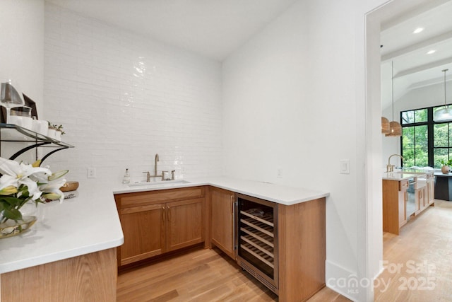408 Ideal Way, Charlotte, NC 28203 - indoor wet bar featuring beverage cooler, light wood-type flooring, vaulted ceiling, backsplash, and stainless steel dishwasher