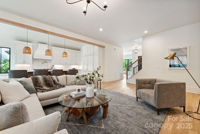 408 Ideal Way, Charlotte, NC 28203 - living room featuring light wood-style flooring, stairs, and recessed lighting