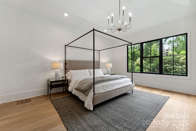 408 Ideal Way, Charlotte, NC 28203 - bedroom featuring a chandelier, light wood-style flooring, and recessed lighting