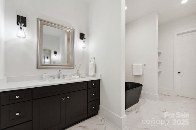 408 Ideal Way, Charlotte, NC 28203 - bathroom featuring marble look tile flooring, a freestanding bath, and vanity