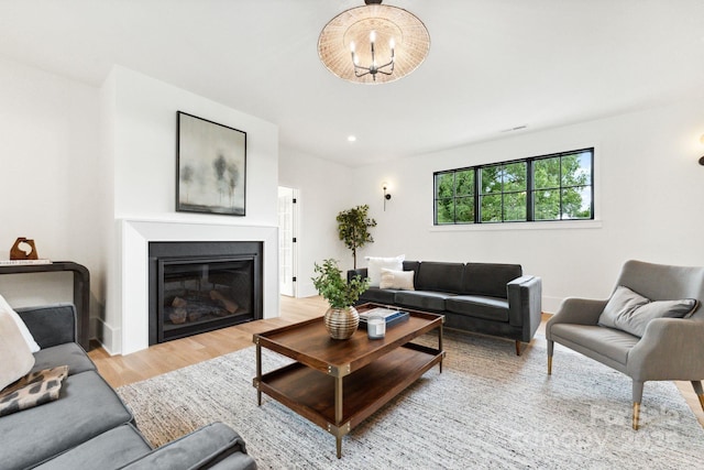 408 Ideal Way, Charlotte, NC 28203 - living area with wood finished floors, a glass covered fireplace, and a chandelier
