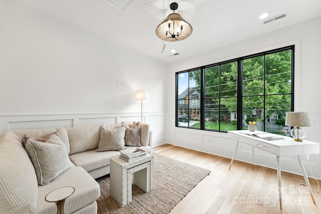 408 Ideal Way, Charlotte, NC 28203 - living area with wood finished floors, a wainscoted wall, and a desk