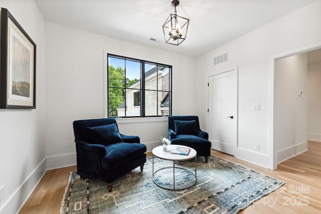 408 Ideal Way, Charlotte, NC 28203 - living area with wood finished floors and a chandelier