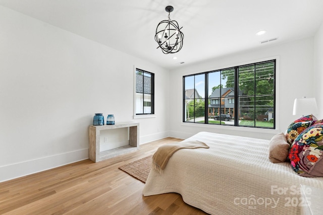 408 Ideal Way, Charlotte, NC 28203 - bedroom with wood finished floors, a chandelier, and recessed lighting