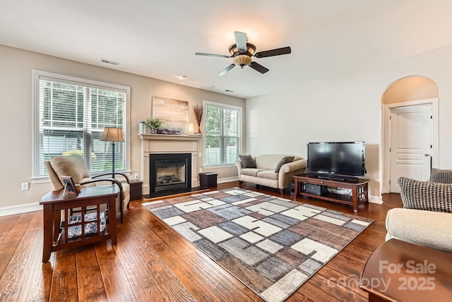 18732 Coachmans Trce, Cornelius, NC 28031 - living room featuring a glass covered fireplace, ceiling fan, and hardwood / wood-style flooring