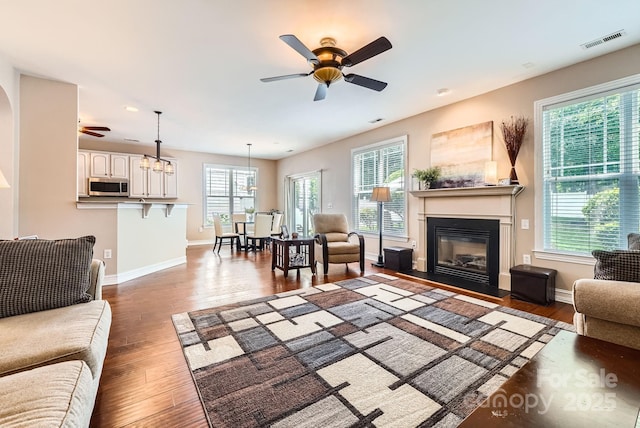 18732 Coachmans Trce, Cornelius, NC 28031 - living room featuring ceiling fan, healthy amount of natural light, and a glass covered fireplace