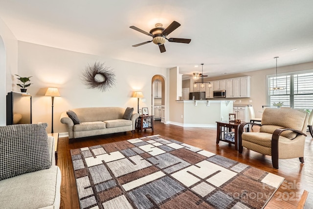18732 Coachmans Trce, Cornelius, NC 28031 - living room featuring arched walkways, wood finished floors, and ceiling fan
