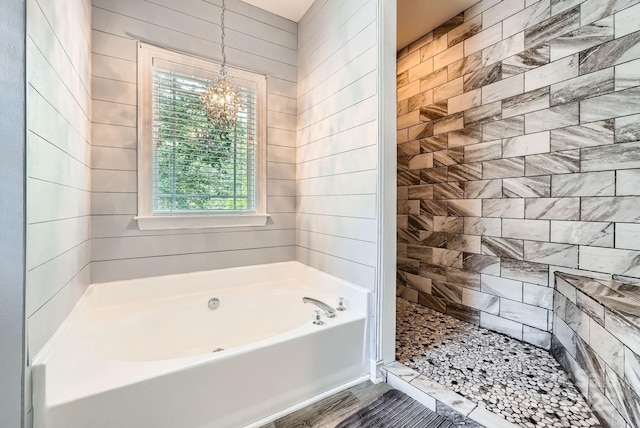 18732 Coachmans Trce, Cornelius, NC 28031 - full bath featuring plenty of natural light, a garden tub, a chandelier, and tiled shower