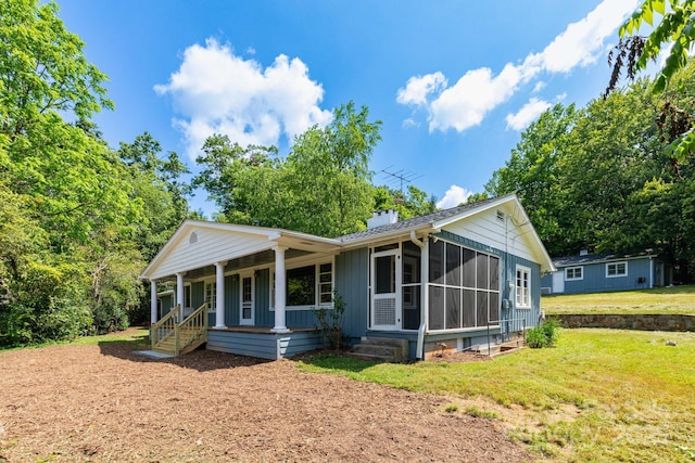 18 Gravely Branch Rd, Fletcher, NC 28732 - view of front facade featuring a chimney, a front yard, a porch, and a sunroom