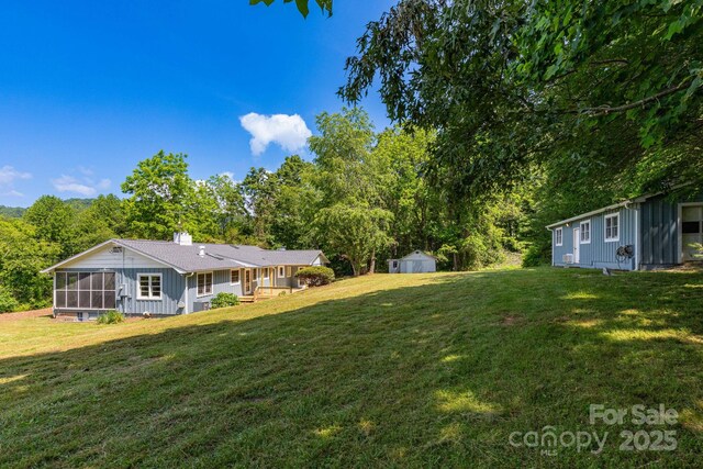 18 Gravely Branch Rd, Fletcher, NC 28732 - view of grassy yard with a sunroom and a storage unit
