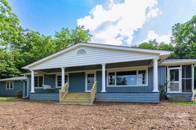 18 Gravely Branch Rd, Fletcher, NC 28732 - view of front of home with covered porch, board and batten siding, and a sunroom