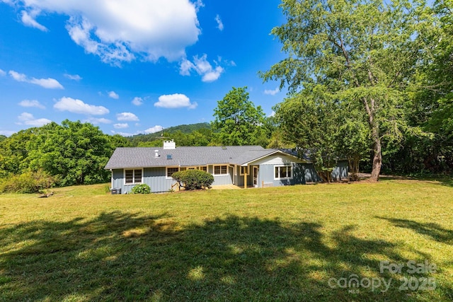 18 Gravely Branch Rd, Fletcher, NC 28732 - back of house with a yard, a chimney, and board and batten siding