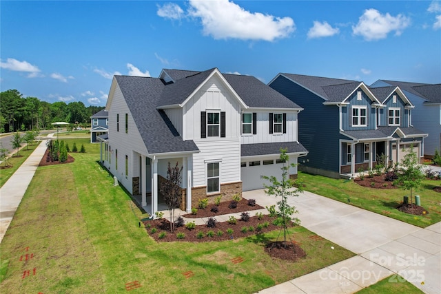 12009 Grinstead Ln Unit 303, Charlotte, NC 28278 - view of front of property with board and batten siding, concrete driveway, a garage, a front lawn, and roof with shingles