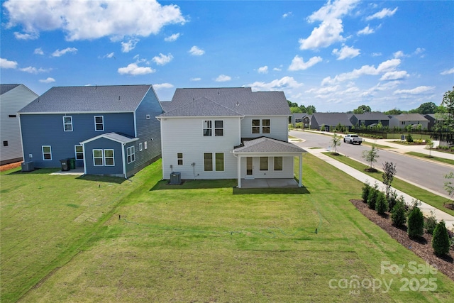 12009 Grinstead Ln Unit 303, Charlotte, NC 28278 - back of house featuring a residential view, a yard, a patio, and central AC unit