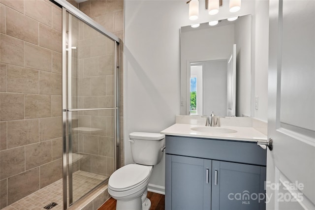 12009 Grinstead Ln Unit 303, Charlotte, NC 28278 - full bathroom with toilet, vanity, a shower stall, and wood finished floors