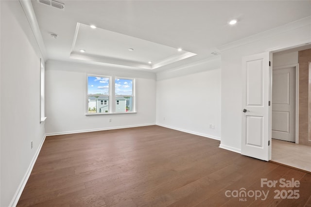 12009 Grinstead Ln Unit 303, Charlotte, NC 28278 - empty room featuring dark wood finished floors, ornamental molding, a tray ceiling, recessed lighting, and baseboards