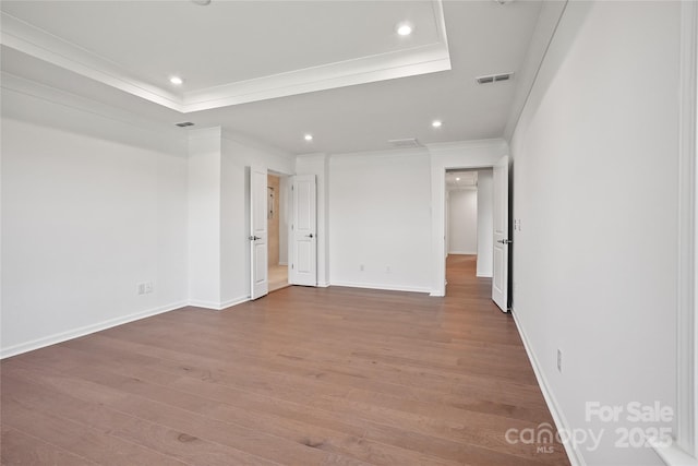 12009 Grinstead Ln Unit 303, Charlotte, NC 28278 - empty room featuring crown molding, wood finished floors, recessed lighting, baseboards, and a tray ceiling