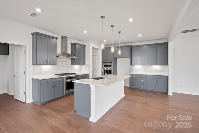 12009 Grinstead Ln Unit 303, Charlotte, NC 28278 - kitchen featuring wall chimney exhaust hood, stainless steel appliances, crown molding, a sink, and gray cabinets
