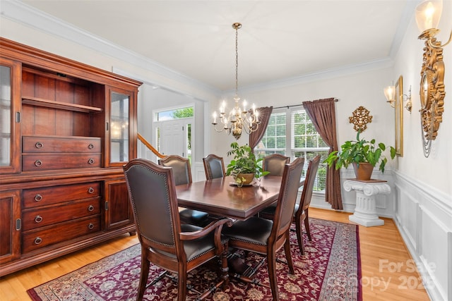 3213 Strawberry Rd, Matthews, NC 28104 - dining area with a chandelier, light wood-style flooring, and crown molding