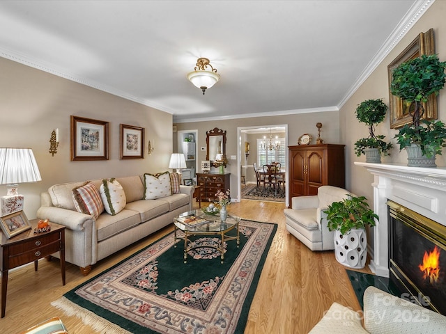 1634-B Union Rd, Gastonia, NC 28054 - living room with crown molding, a chandelier, light wood-style flooring, and a fireplace with flush hearth