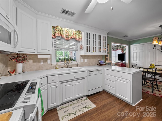 1634-B Union Rd, Gastonia, NC 28054 - kitchen featuring white appliances, a peninsula, crown molding, white cabinetry, and dark wood-type flooring