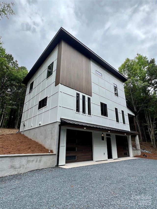 908 Apex Dr, Albemarle, NC 28001 - view of front of house with an attached garage, gravel driveway, a standing seam roof, and metal roof