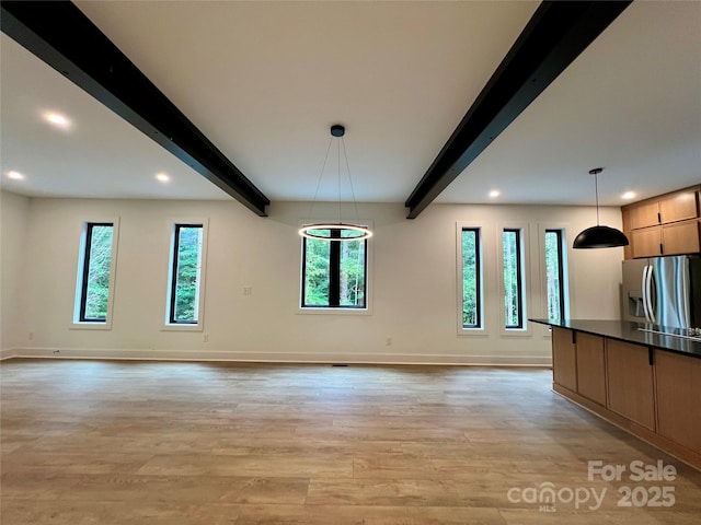 908 Apex Dr, Albemarle, NC 28001 - unfurnished living room featuring beam ceiling, baseboards, light wood-style floors, and recessed lighting