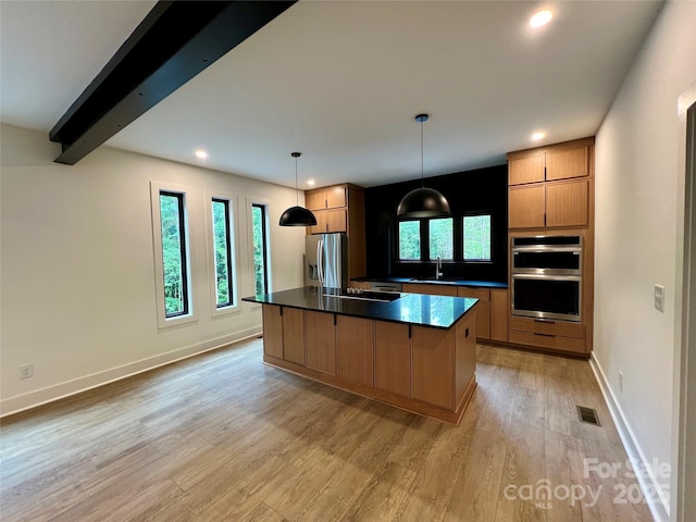908 Apex Dr, Albemarle, NC 28001 - kitchen featuring stainless steel appliances, dark countertops, light wood-style floors, a sink, and recessed lighting