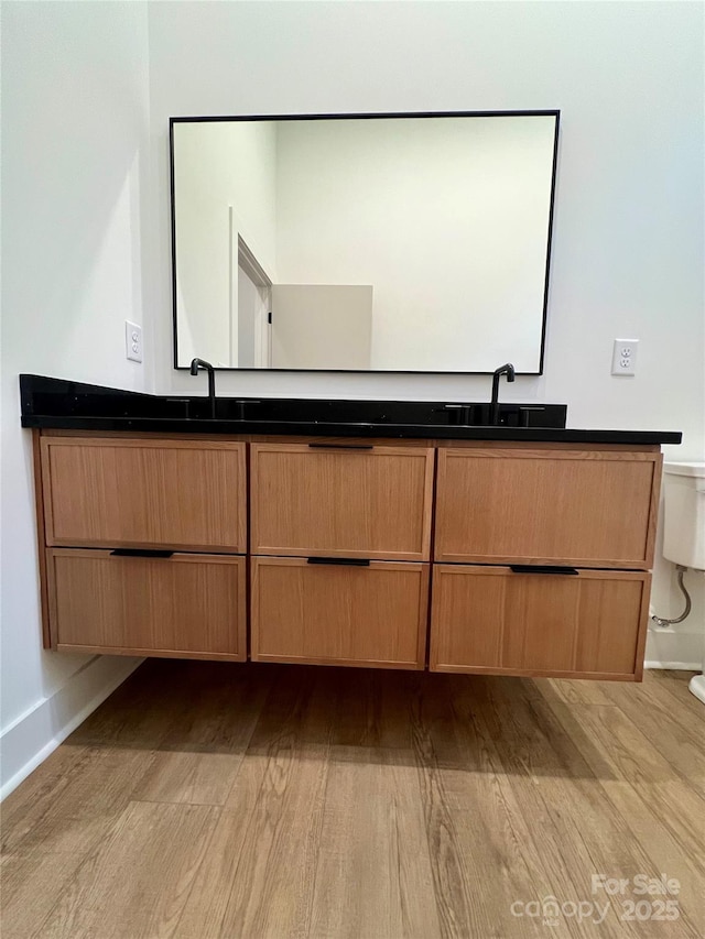 908 Apex Dr, Albemarle, NC 28001 - bathroom featuring toilet, wood finished floors, and double vanity