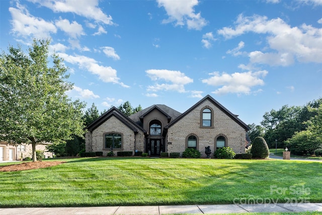 3441 Club Ridge Ct, Gastonia, NC 28056 - french country inspired facade with brick siding, a front lawn, and french doors