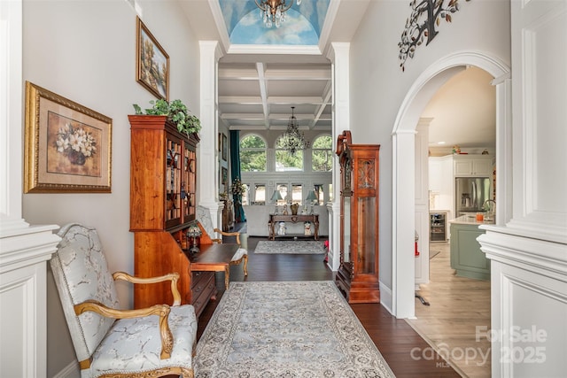 3441 Club Ridge Ct, Gastonia, NC 28056 - foyer with a chandelier, coffered ceiling, dark wood-type flooring, arched walkways, and beamed ceiling